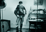 Thumb_person-with-jacket_-jeans-belt-with-a-face_-fur-scraf_-boots_-and-a-newspaper-in-their-boot-posing