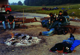 Thumb_campfire-6-people-sleeping_-some-on-the-ground-some-on-chairs-and-three-people-talking-in-the-countryside