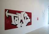 Thumb_piece-of-graffti-tag-_tomi_-in-white-infront-of-red-background