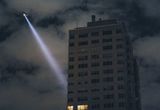 Thumb_helicopter-shining-light-to-the-side-of-a-building-possibly-alluding-to-the-person-from-the-balcony-being-a-terrorist