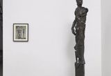 Thumb_one-greyish-black-staue-of-a-humanoid-next-to-painting-of-slender-figure