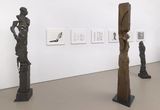 Thumb_three-statues_-one-brown-and-two-greyish-black-resembling-humans-and-6-framed-pieces-behind-it