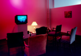 Thumb_6-chairs-facing-an-old-boxy-tv-under-pink-light-and-a-painting-next-to-the-seats